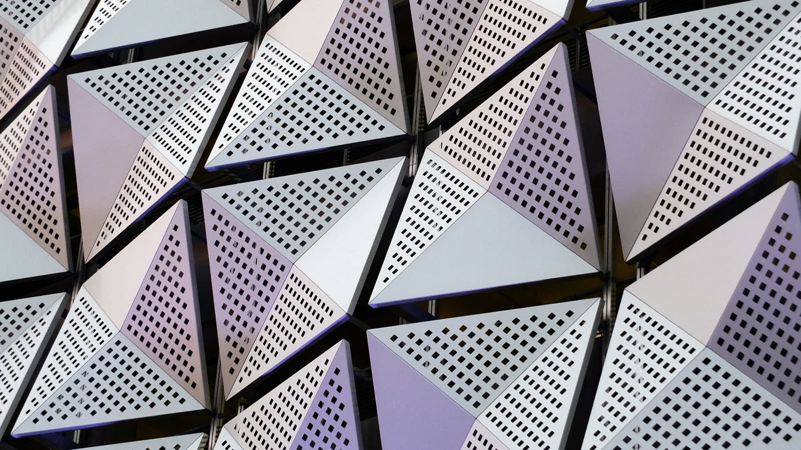 Silver and purple geometric steel cladding with angular patterns.