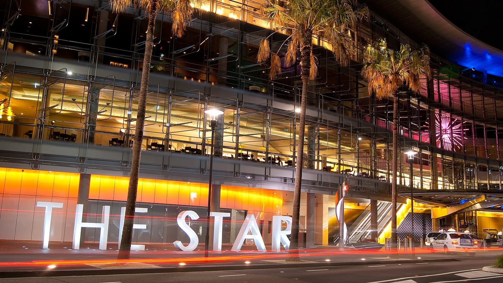 The Star casino in Pyrmont, Sydney. A photograph of the casino's exterior and signage, with palm trees.