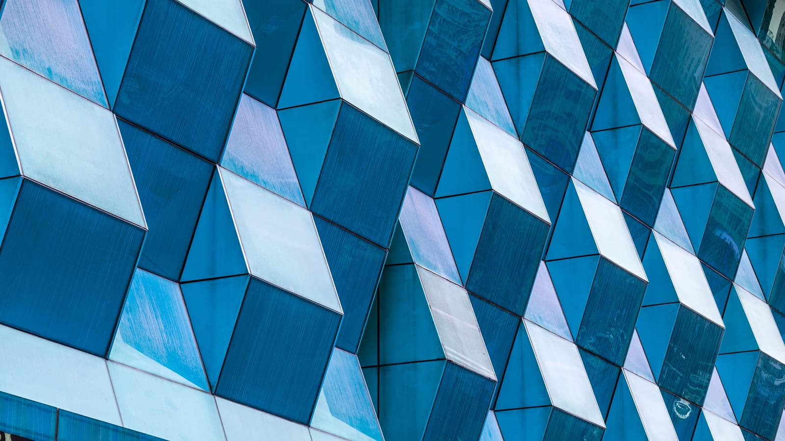 Exterior of a modern office building with a blue, patterned facade.