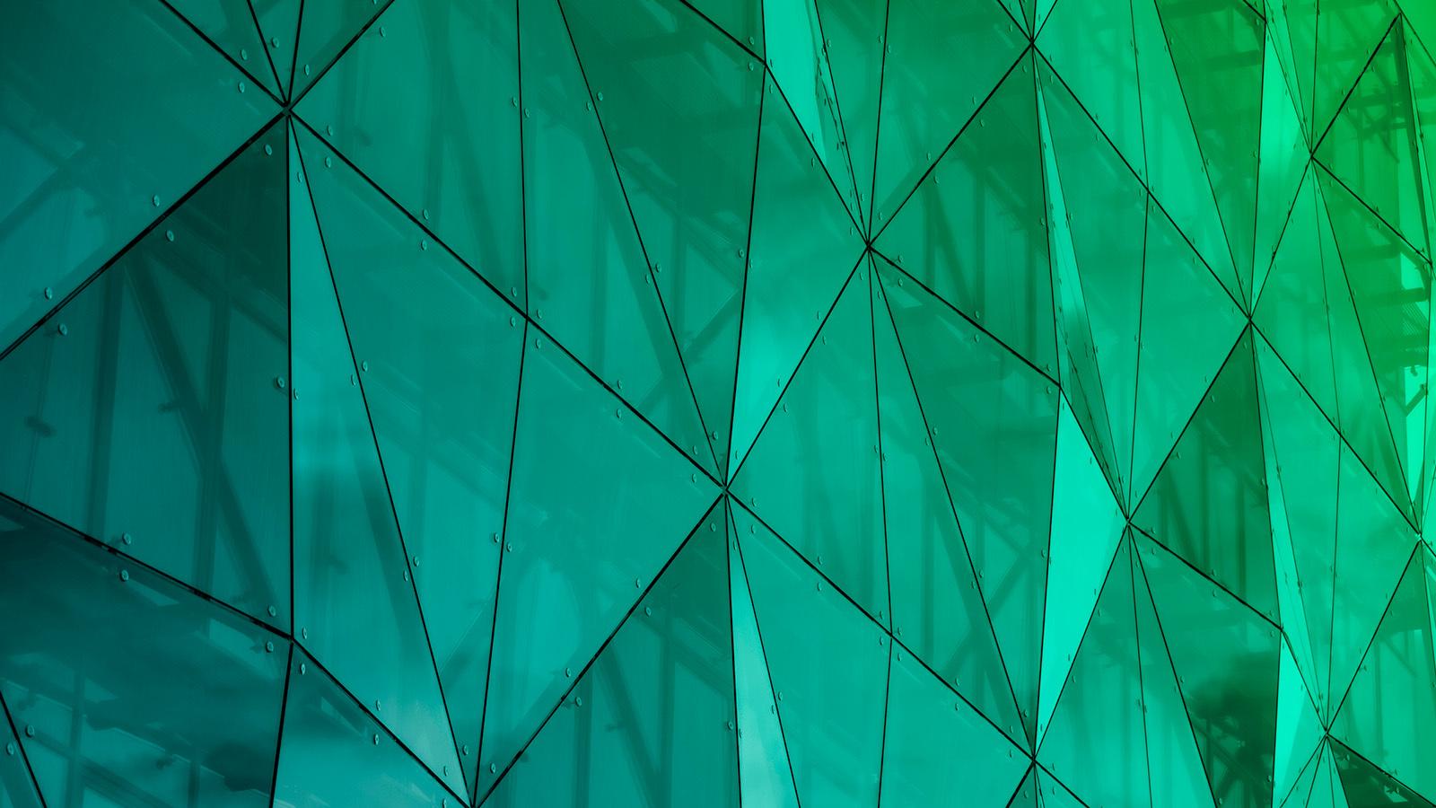 Green/Turquoise glass façade on a modern office building.