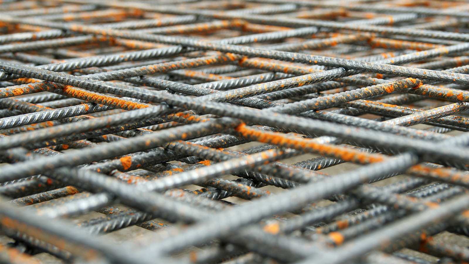 Criss-crossing metal bars – concrete reinforcement.