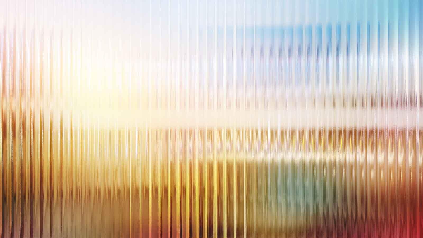 Patterned faceted glass with reflections. (Blurred gradient.)